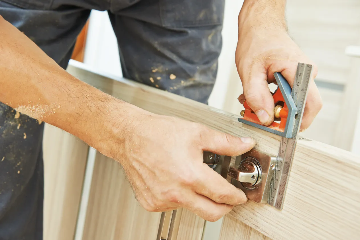 handyman repairs a door